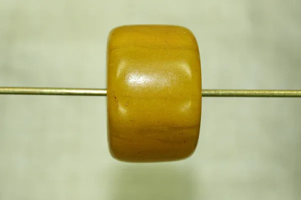 Pale yellow amber cylindrical bead