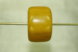Pale yellow amber cylindrical bead