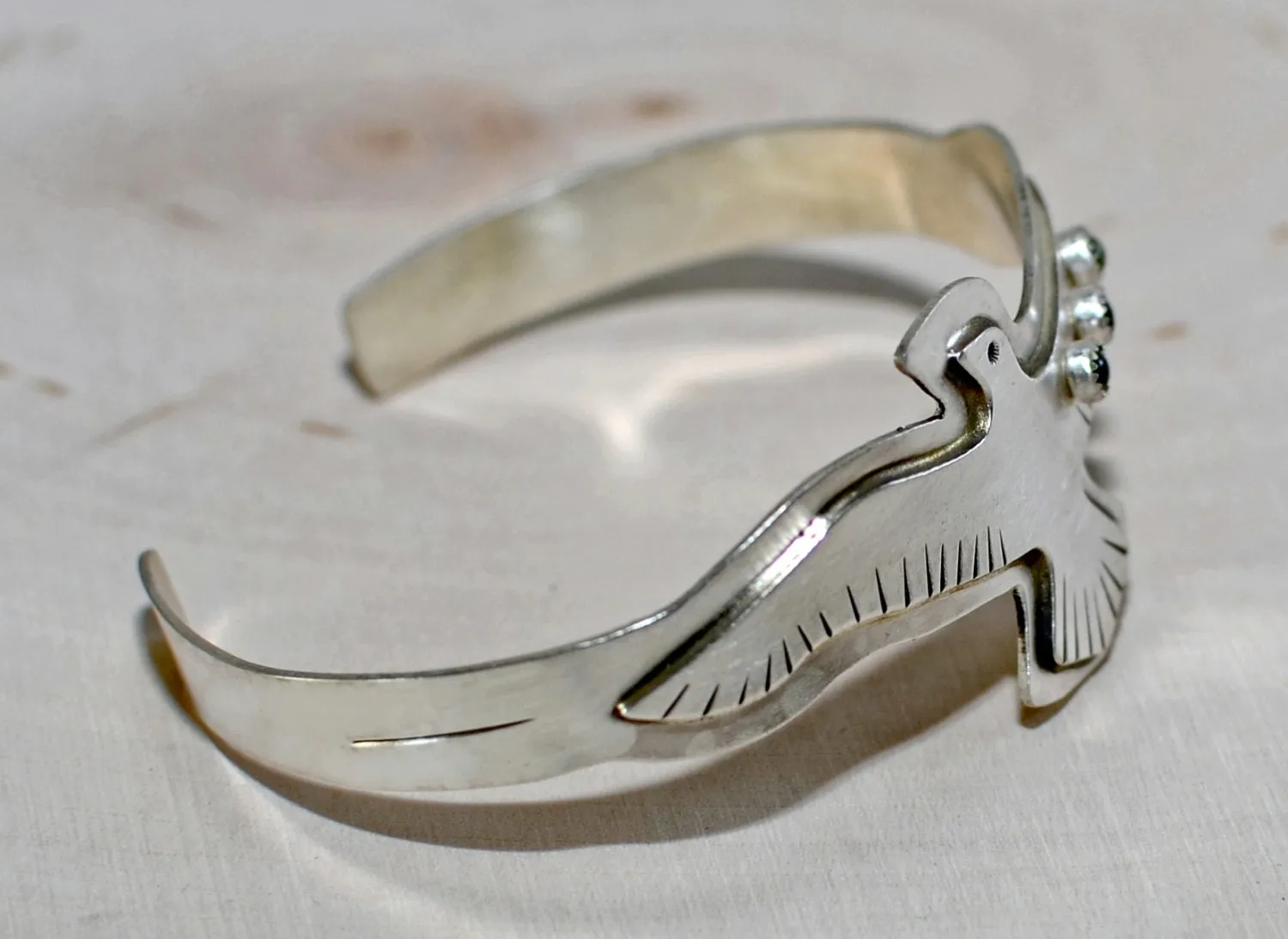 Sterling silver bird bracelet with red Garnet and green Peridots