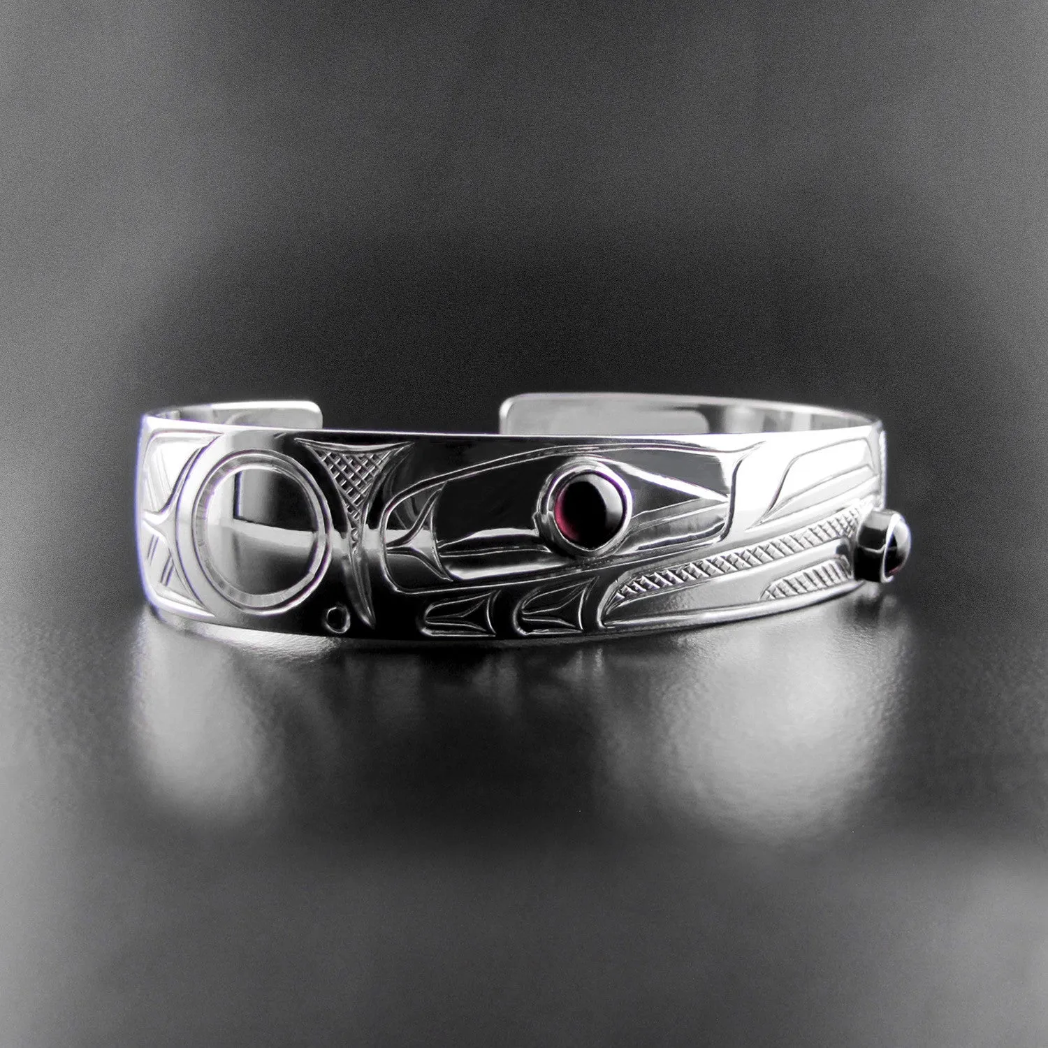 Elegant Sterling Silver Bracelet Featuring Raven Design with Garnet Accents