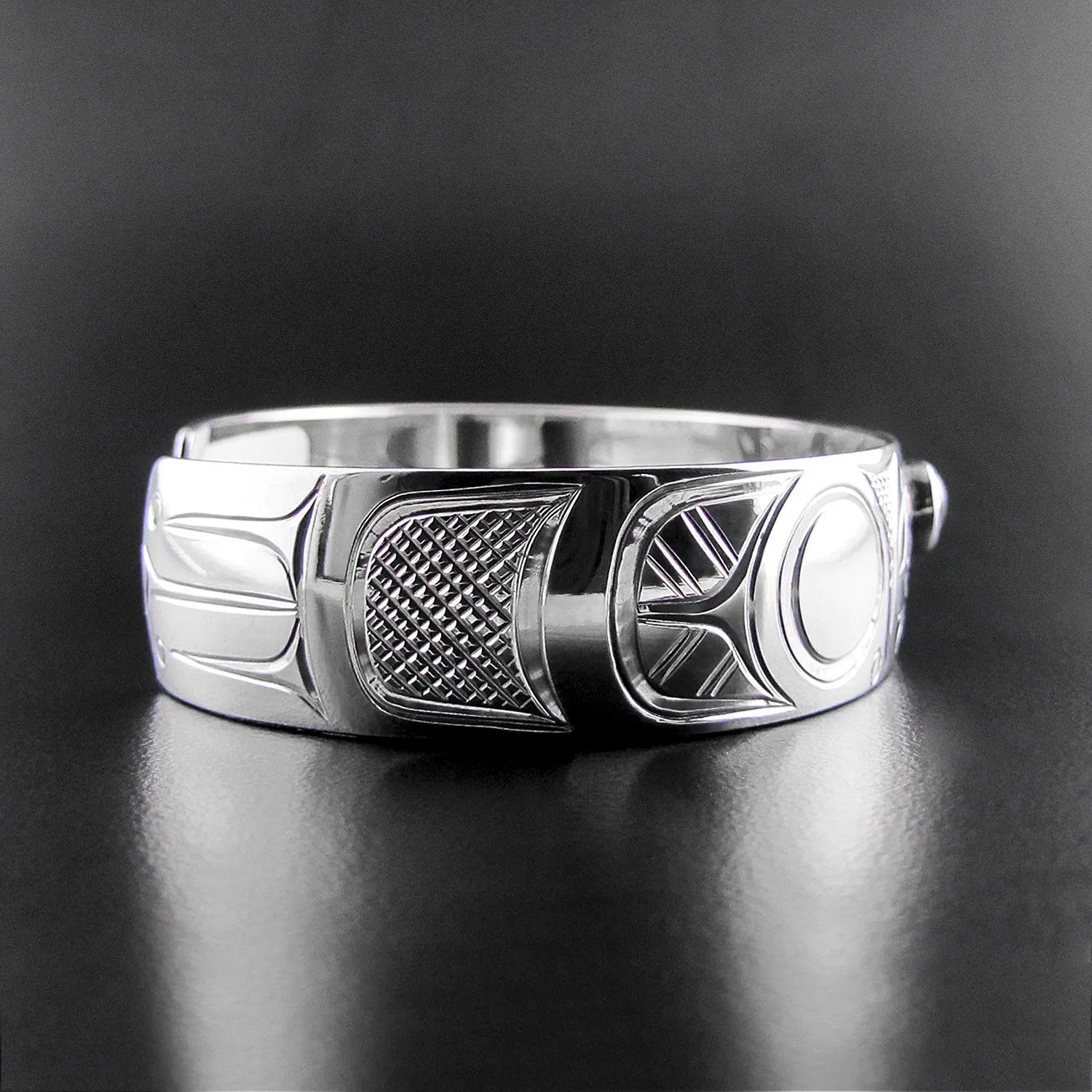 Elegant Sterling Silver Bracelet Featuring Raven Design with Garnet Accents